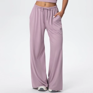 Detail of lilac wide-leg trousers with elastic drawstring waistband and side pockets