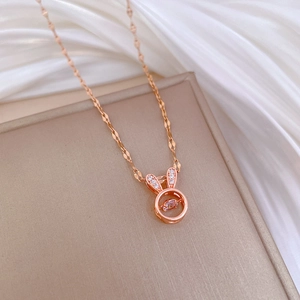 Rose gold rabbit necklace with a dancing crystal pendant on soft silk background