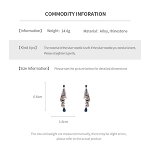 Macro detail of teardrop geometric earrings with blue stone and silver diamond settings