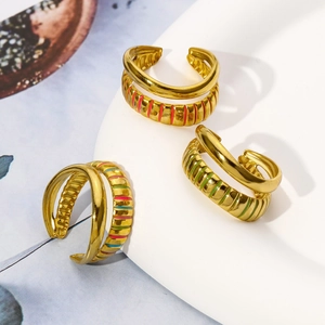 Detailed macro view of 18K gold plated rings with vibrant multi-color enamel stripes