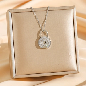 Elegant silver V-letter handbag pendant necklace with cubic zirconia on silk cushion