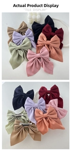 Detailed view of satin bow hair clips in various colors with metal alligator backs