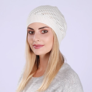 Detail of white hollow crochet knit beanie featuring a ribbed edge for winter warmth