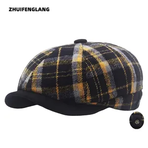 Plaid wool newsboy cap with black brim and decorative metal side button detail