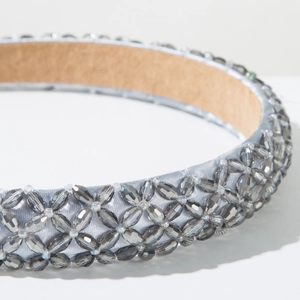 Detail of hand-woven grey crystal beaded headband with light blue satin fabric