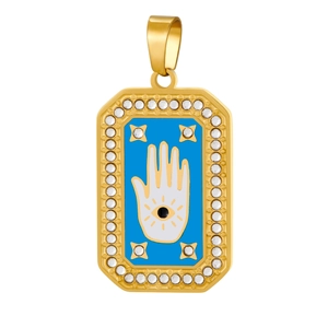 Detailed view of Hamsa Hand pendant with blue enamel and sparkling white crystals