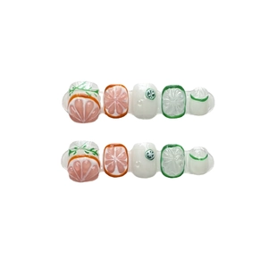 Handmade 3D fruit press-on nails featuring orange and lime citrus relief designs