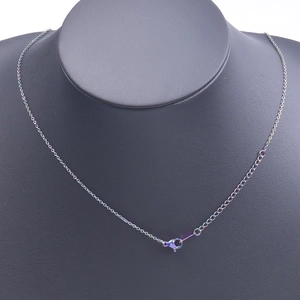 Detailed close-up of rainbow metal chain with lobster clasp and extension on mannequin