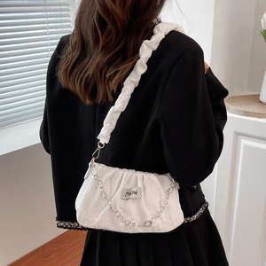 White ruched cloud bag with silver flower chain and pleated strap shown on model
