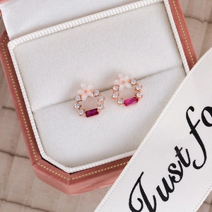 Detail of pink flower stud earrings with crystals in a velvet jewelry box