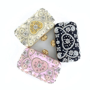 Detail of beaded evening bag with exquisite pearls, rhinestones and heart-shaped patterns