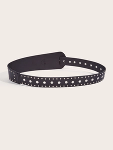 Close-up of black punk belt featuring silver metal rivets and hollow grommet details