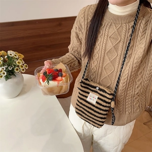 Detail of plush striped crossbody bag with soft texture and chic rope strap