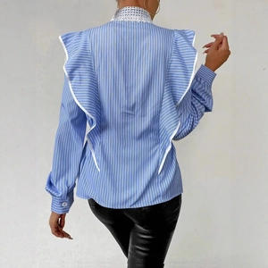 Rear view of striped blue shirt featuring a large ruffle back and white lace collar detail