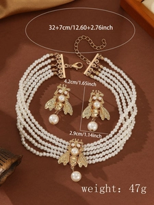 Detailed dimensions of gold bee necklace and faux pearl earrings set with size labels