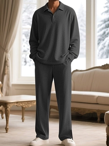 Close-up of men's dark grey polo lounge set with textured waffle knit pattern fabric