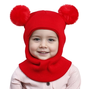 Detail of red knit baby winter hat with double pom-poms and integrated neck warmer