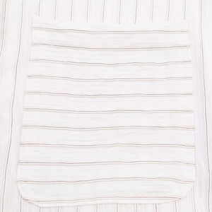 Detailed macro view of the striped fabric texture and stitched pocket on this blouse
