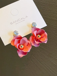 Detailed close-up of pink camellia floral earrings with gradient petals and clear zircons