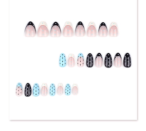 French tip almond press-on nails with black polka dot design in blue and pink tones