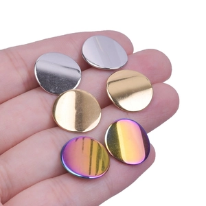 Close-up of circular 304 stainless steel studs in silver, gold, and aurora rainbow finishes