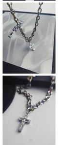 Close-up of titanium steel cross necklace with zircon inlay and two-tone chain detail