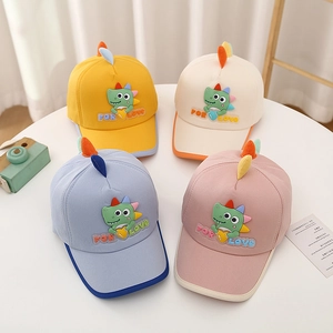 Detail of colorful kids baseball hats featuring 3D cartoon dinosaur and embroidered text