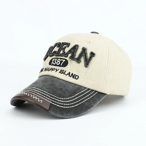 Detail of OCEAN 3D embroidery and vintage distressed brim on a two-tone baseball cap