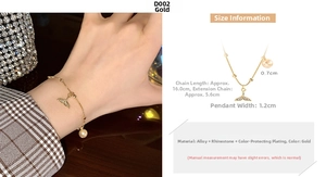 Detail of gold whale tail charm bracelet with rhinestones and pearl on wrist