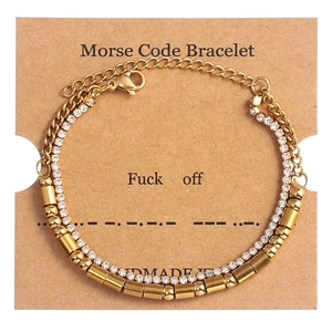 Detail of gold Morse code double-layer bracelet on branded gift card display