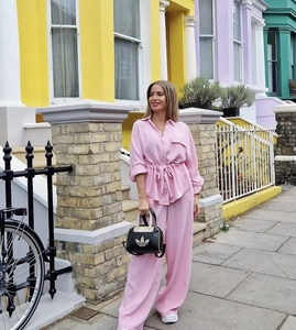 Detailed shot of pink silk-like safari lounge set with belted waist and wide-leg pants