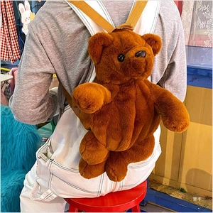 Detailed view of dark brown plush bear backpack with adjustable shoulder straps on model