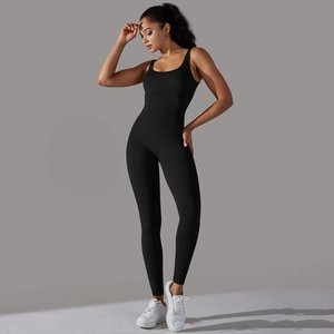Close-up of black ribbed seamless yoga bodysuit showing the elastic fabric texture