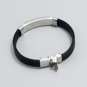Cross-themed stainless steel bracelet with black silicone strap and fold-over metal clasp