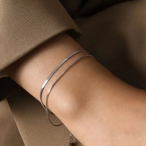 Minimalist double-layered silver snake chain bracelet for women on elegant model wrist