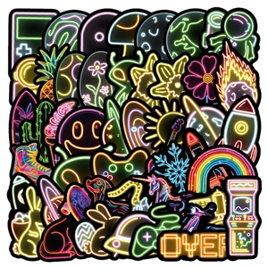 Vibrant neon graffiti stickers featuring astronaut and arcade designs on black background