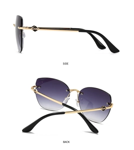 Detail view of rimless cat-eye sunglasses with gradient lenses and gold chain temples
