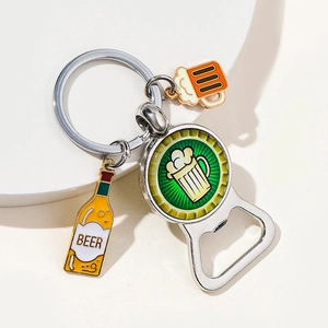 Detail of silver metal keychain with beer glass charms and green bottle opener