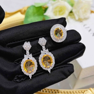Detailed macro view of luxury oval cut yellow zircon jewelry set with silver finish