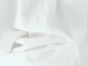 Close-up of white cotton fabric texture and natural fiber grain on lace mini dress