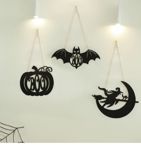Detail of Halloween black iron hanging signs featuring Boo pumpkin, bat, and witch silhouettes