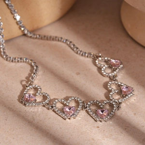 Elegant hollow heart necklace featuring pink zircon stones and a classic tennis chain style