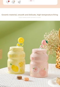 Detail of peach and lemon ceramic cups in Yakult bottle shape with decorative straws