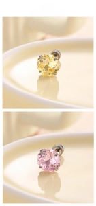 Macro detail of hexagonal cut pink and yellow zircon earrings with six-prong settings