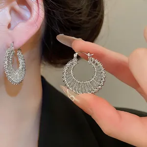 18k gold plated hollow woven hoop earrings with intricate metallic texture for women