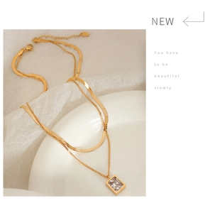 Detail of double-layer gold titanium necklace with rectangular zircon pendant