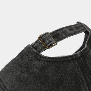 Detail of adjustable brass buckle on vintage dark grey washed cotton baseball cap