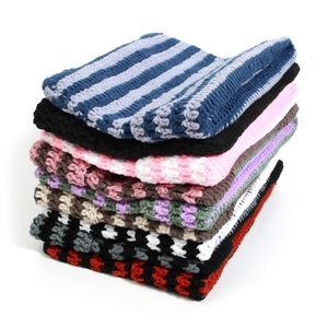Detailed close-up showing thick handmade crochet texture and various striped knit patterns
