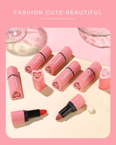 Close-up of heart-shaped matte lipsticks with velvet finish and elegant pearl accents