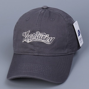 Close-up of dark gray cotton baseball cap featuring Keeplucky 3D embroidery and product tag
